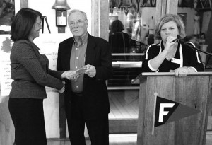 Retired FHT Board member Gene Black is awarded the Bruce Espey Community Service award by Addie Drolette, FHT Board president with Executive Director, Annie Connolly speaking at podium